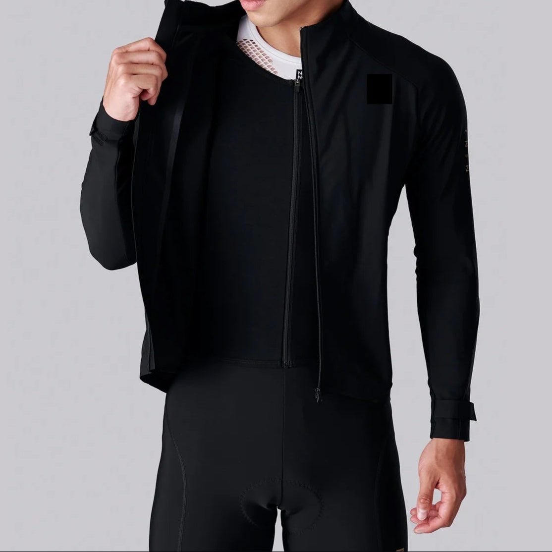 Man wearing a black jacket on a gray background